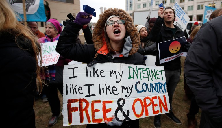 FILE - In this Dec. 14, 2017 file photo, Lindsay Chestnut of Baltimore holds a sign that reads "I like My Internet Like I Like my Country: Free & Open" as she protests near the Federal Communications Commission (FCC), in Washington where the FCC was scheduled to meet and vote on net neutrality. On Tuesday, March 13, 2018, a California lawmaker introduced legislation that looks to maintain net-neutrality rules recently scuttled by the Federal Communications Commission, setting up a likely showdown with influential internet companies and, if his bill passes, with the Trump administration in court. 