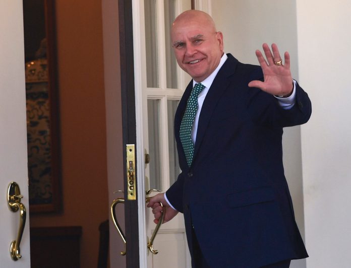 National security adviser H.R. McMaster waves as he walks into the West Wing, Friday.