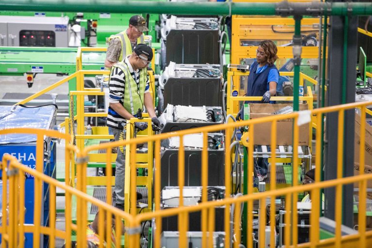 Workers build washing machines on the assembly line at the Samsung washing machine facility, Friday, March 16, 2018, in Newberry, S.C.
