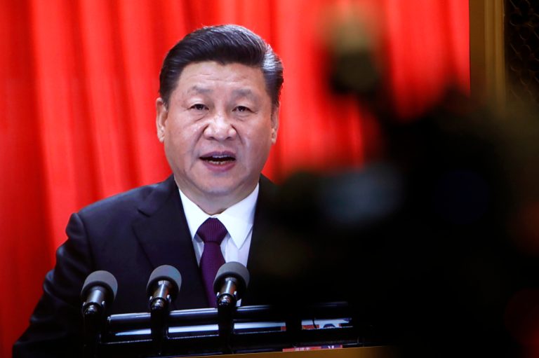 A TV screen shows Chinese President Xi Jinping delivering a speech at the closing session of the annual National People's Congress (NPC) at the Great Hall of the People in Beijing, Tuesday, March 20, 2018.