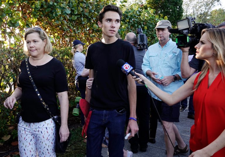 In this Feb. 28, 2018, file photo, student David Hogg speaks to the media as he returns to Marjory Stoneman Douglas High School in Parkland, Fla.