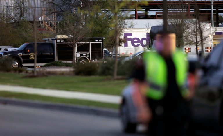Emergency vehicles sit in front of a FedEx distribution center where a package exploded Tuesday in Schertz, Texas. Authorities believe the package bomb is linked to the recent string of Austin bombings.