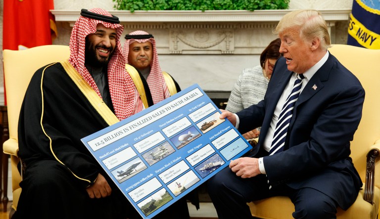 President Donald Trump shows a chart highlighting arms sales to Saudi Arabia during a meeting with Saudi Crown Prince Mohammed bin Salman in the Oval Office of the White House, Tuesday, March 20, 2018, in Washington.