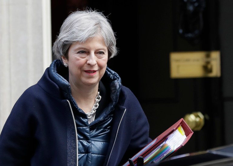 British Prime Minister Theresa May leaves Downing Street in London to attend a session of Parliament.