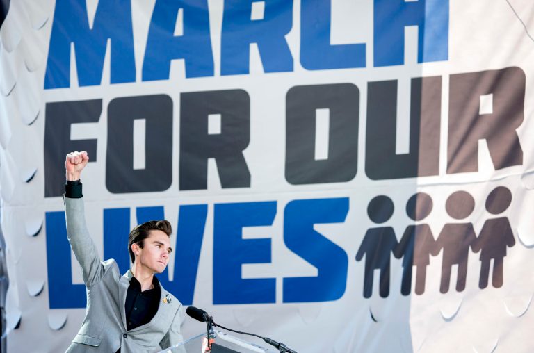 David Hogg, a survivor of the mass shooting at Marjory Stoneman Douglas High School in Parkland, Fla., raises his fist after speaking during the "March for Our Lives" rally in support of gun control in Washington, Saturday, March 24, 2018.
