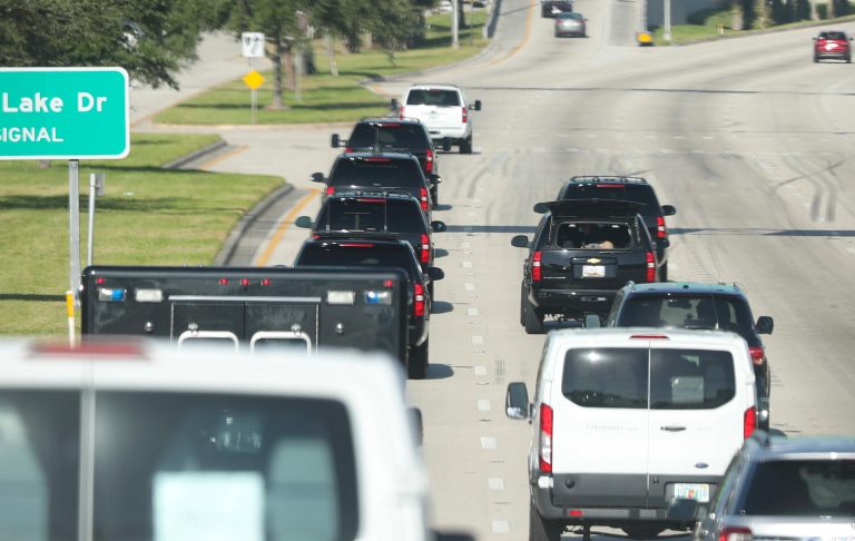Motorcade vehicles are shown transporting President Trump.