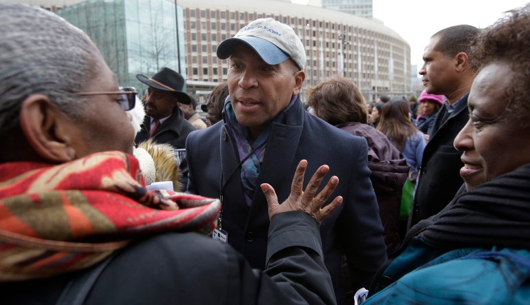 Former Mass. Gov. Deval Patrick, center, greets people in a crowd, Monday, April 2, 2018, before a remembrance on City Hall Plaza, in Boston, for Martin Luther King Jr., who was assassinated 50 years ago this week. Dozens of speakers aged 5 to 91 took turns reading short passages from King's last speech during the remembrance. King originally delivered the speech in Memphis, Tennessee, on the eve of his April 4, 1968, death.