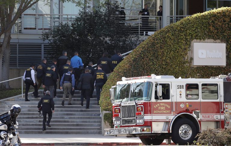 Law enforcement officials walk toward YouTube offices in San Bruno, Calif., Tuesday, April 3, 2018. A woman opened fire Tuesday at YouTube headquarters, wounding some people before fatally shooting herself as terrified employees huddled inside, police and witnesses said.