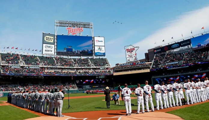 A flyover of four Air Force jets comes over Target Field after the national anthem as the Seattle Mariners and the Minnesota Twins line up prior to the Twins home-opener baseball game Thursday, April 5, 2018, in Minneapolis.