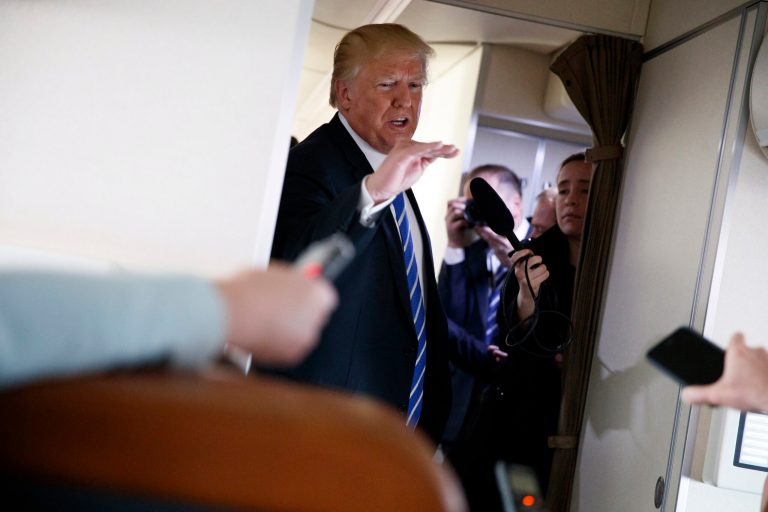 President Trump talks with reporters aboard Air Force One on a flight to Andrews Air Force Base, Md., on Thursday.