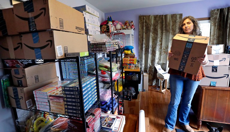 In this April 6 photo, Adrienne Kosewicz, owner of Play It Safe World Toys, poses for a portrait in her home office in Seattle. Kosewicz pays $3,600 a year for tax collection software to handle payments and reports to her home state, Washington. Her Seattle-based online business sells through Amazon, which handles computation and collection.