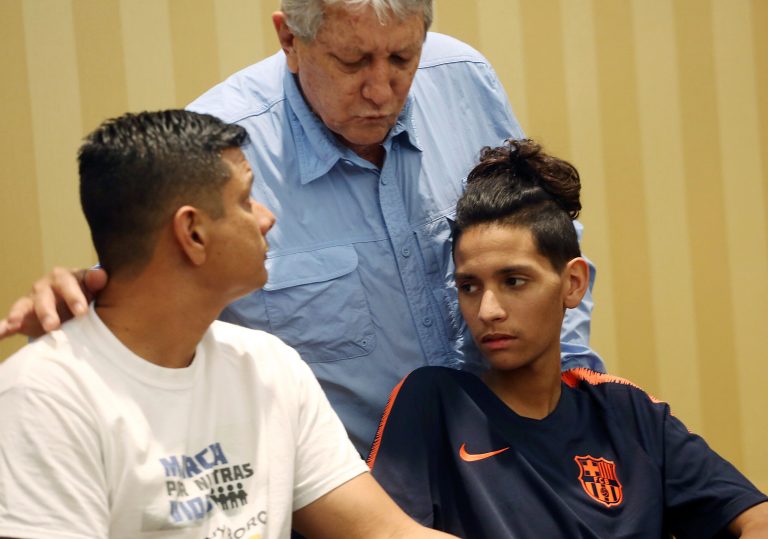 Anthony Borges, right, and his father, Roger, left, listen to his grandfather Alfredo during a news conference in Plantation, Fla., Friday, April 6, 2018. An attorney for Anthony Borges read a statement from him criticizing Broward County Sheriff Scott Israel and School Superintendent Robert Runcie for the deaths and injuries sustained during the Feb. 14 massacre at Marjory Stoneman Douglas High School in Parkland, Fla. Anthony Borges sustained five bullet wounds after he used his body to block a classroom door during the shooting. (AP Photo/Marta Lavandier)
