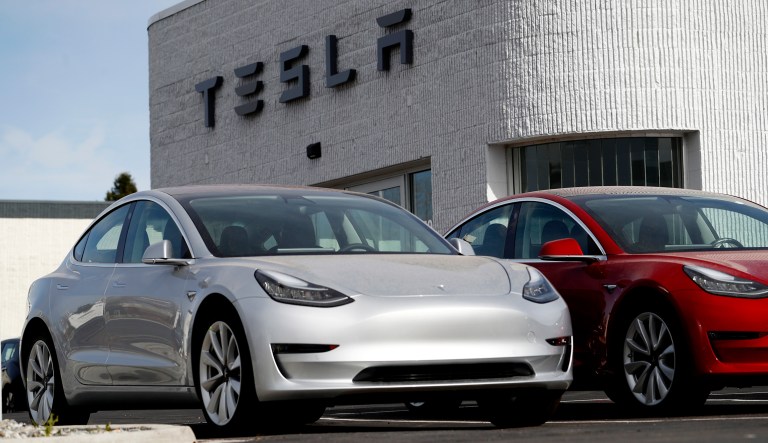Unsold 2018 Model 3 Long Range vehicles sit on a Tesla dealer's lot in the south Denver suburb of Littleton, Colo. 