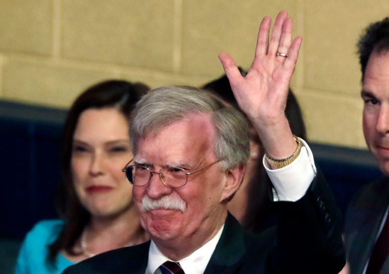 National security adviser John Bolton waves as he attends a roundtable discussion on tax cuts for Florida small businesses with President Donald Trump, in Hialeah, Fla.