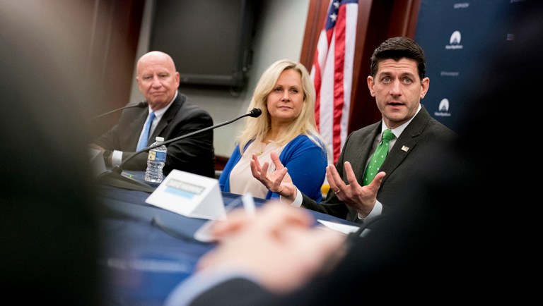 House Speaker Paul Ryan of Wis., accompanied by House Ways and Means chairman Rep. Kevin Brady, R-Texas, left, and Melissa Bercier of Couch Clarity, Ill., center, speaks during a roundtable with American taxpayers on tax reform on Capitol Hill, Tuesday, April 17, 2018, in Washington.