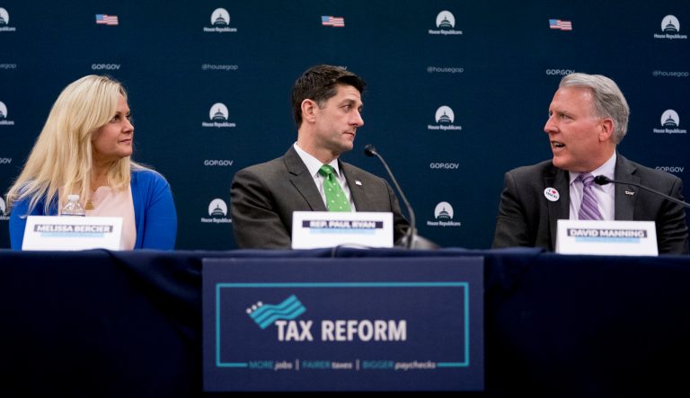 Then-House Speaker Paul Ryan of Wis., center, accompanied by Melissa Bercier of Couch Clarity, Ill., left, listens to TCW President David Manning, right, as he speaks during a roundtable with American taxpayers on tax reform on Capitol Hill, Tuesday, April 17, 2018, in Washington. 