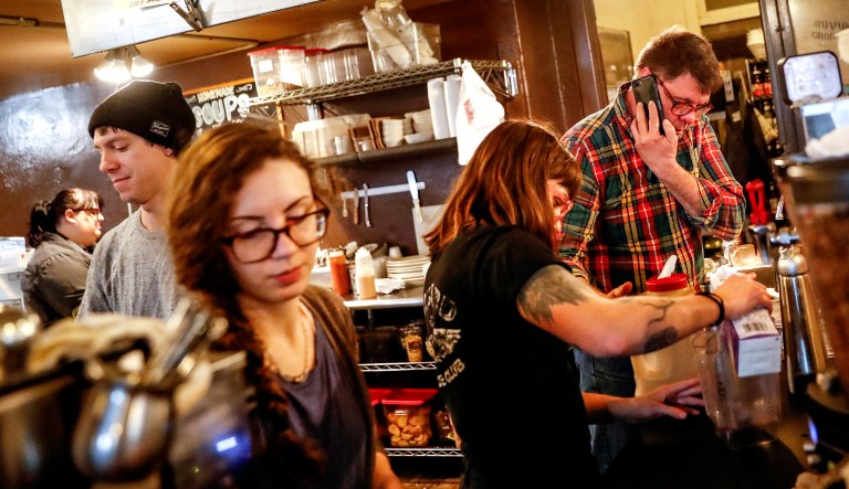 People work at a coffee shop in Cincinnati.