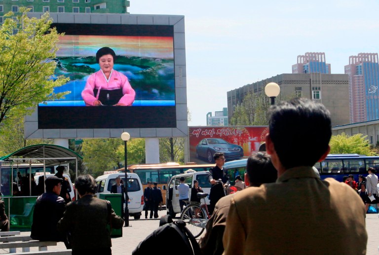 North Koreans watch as their country's most famous newscaster announces leader Kim Jong Un's proposal to suspend nuclear tests and long-range missile launches on a giant screen on Pyongyang's newly built Mirae Scientists' Street Saturday, April 21, 2018. Kim is to hold a summit with South Korea's president next week and with U.S. President Donald Trump in late May or June.