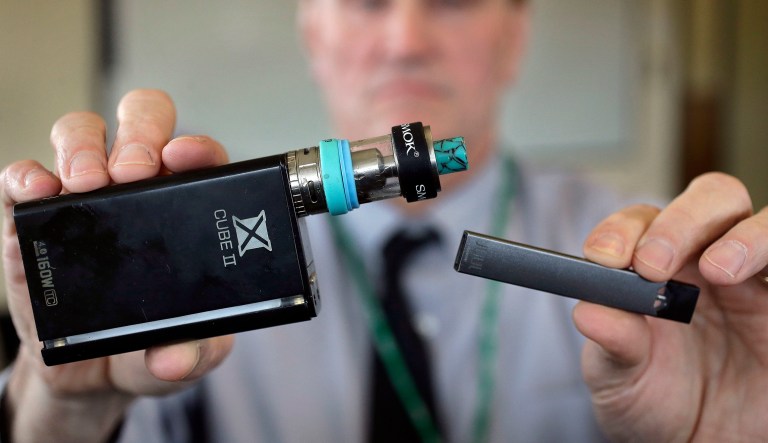 E-cigarette devices are shown above. They heat liquid into an inhalable vapor that's sold in sugary flavors like mango and mint, and often with the addictive drug nicotine.