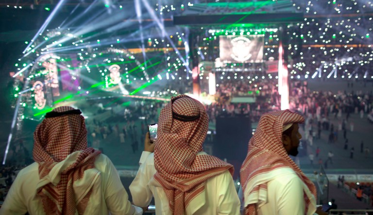 Fans film the opening of the "Greatest Royal Rumble" event in Jiddah, Saudi Arabia, on Apr. 27, 2018. A previous WWE event held in the ultraconservative kingdom in 2014 was for men only. But Friday night's event in Jiddah included both women and children in attendance.