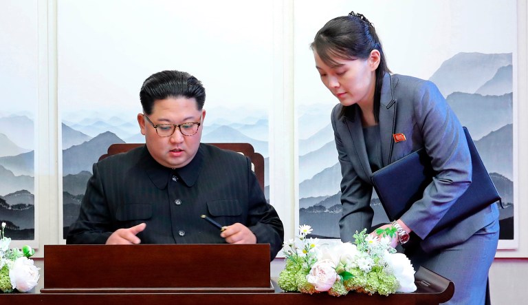 In this photo from April, North Korean leader Kim Jong Un signs a guestbook next to his sister Kim Yo Jong, right.