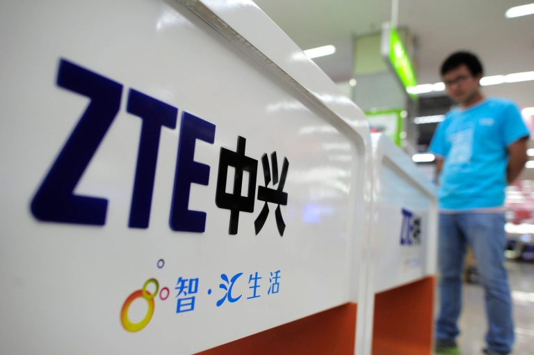 FILE - In this Oct. 8, 2012, file photo, a salesperson stands at counters selling mobile phones produced by ZTE Corp. at an appliance store in Wuhan in central China's Hubei province. Chinese tech company ZTE said Sunday, May 6, 2018 that it applied to the U.S. Commerce Department to suspend a seven-year ban on doing business with U.S. technology exporters 