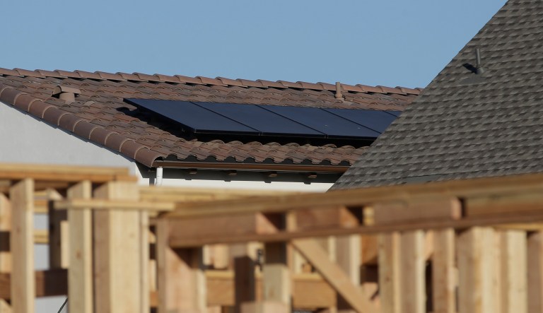 In this photo taken Monday, May 7, 2018, solar panels are seen on the rooftop on a home in a new housing project in Sacramento, Calif. The California Energy Commission will take up a proposal, Wednesday, May 9, 2018 , to require solar panels on new residential homes and low-rise apartment buildings up to three starting in 2020.