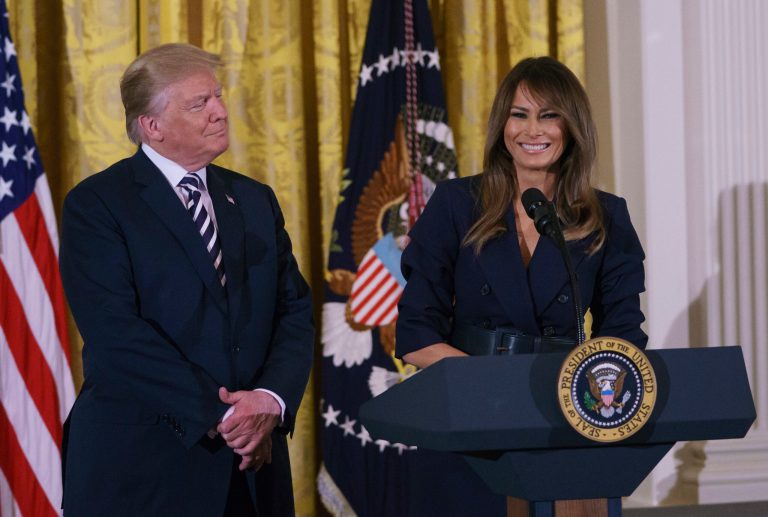 President Donald Trump looks to first lady Melania Trump as she speaks in the East Room of the White House in Washington, Wednesday, May 9, 2018, during an event celebrating military mothers and spouses.