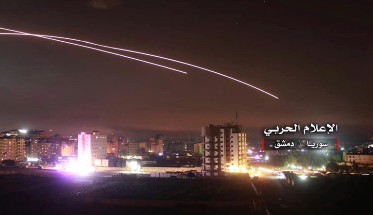 This photo provided early Thursday, May 10, 2018, by the government-controlled Syrian Central Military Media, shows missiles rise into the sky as Israeli missiles hit air defense position and other military bases, in Damascus, Syria. The Israeli military on Thursday said it attacked "dozens" of Iranian targets in neighboring Syria in response to an Iranian rocket barrage on Israeli positions in the Golan Heights, in the most serious military confrontation between the two bitter enemies to date.