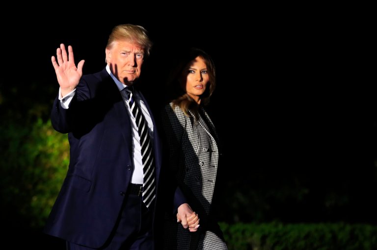President Donald Trump, with first lady Melania Trump, waves as he leaves the White House in Washington, early Thursday, May 10, 2018, to greet three freed Americans detained in North Korea for over a year, who are arriving at Joint Base Andrews, Md.
