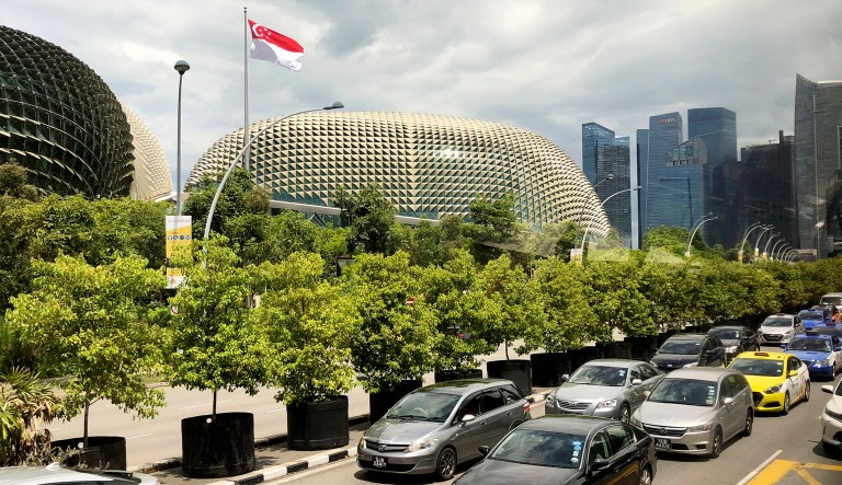 The national flag of Singapore flies against the financial skyline lining the edge of the Singapore River on Thursday in Singapore. President Trump will meet with North Korea's leader, Kim Jong Un, in Singapore on  June 12, Trump announced in a tweet.