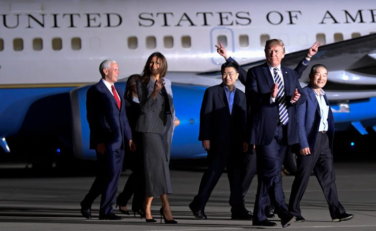 President Donald Trump walks with Tony Kim, third right, Kim Dong Chul, right, and Kim Hak Song, behind Trump, the three Americans detained in North Korea for more than a year as they arrive at Andrews Air Force Base in Md., Thursday, May 10, 2018. Walking with Trump is Vice President Mike Pence, left, and first lady Melania Trump.