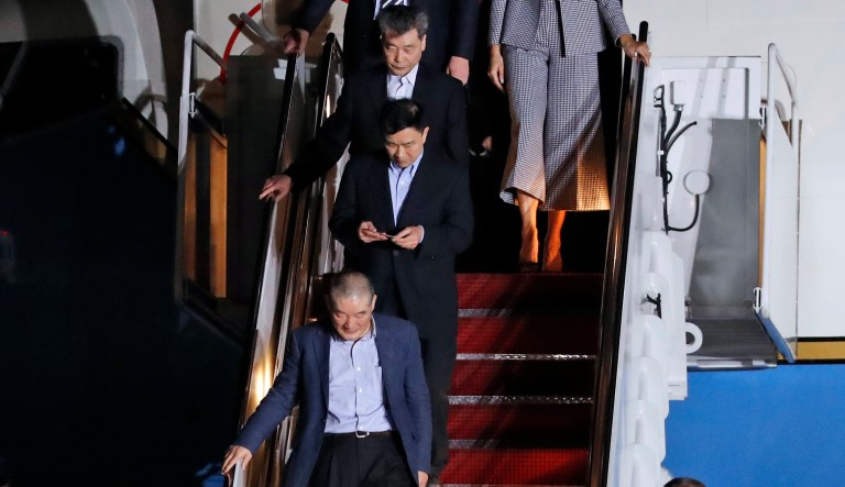 Three Korean-Americans who were detained in North Korea for more than a year, Kim Dong Chul, from bottom, Tony Kim and Kim Hak Song get off a military airplane after they were greeted by President Donald Trump and first lady Melania Trump upon their arrival at Andrews Air Force Base in Md., Thursday, May 10, 2018. The three Korean-Americans were greeted by Trump beneath a giant American flag after they returned to the mainland U.S. early Thursday.