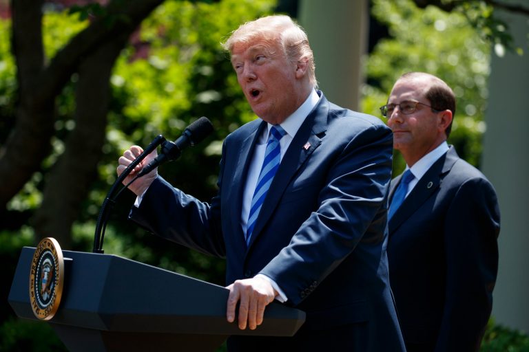 Secretary of Health and Human Services Alex Azar looks on as President Donald Trump speaks during an event about prescription drug prices in the Rose Garden of the White House, Friday, May 11, 2018, in Washington.