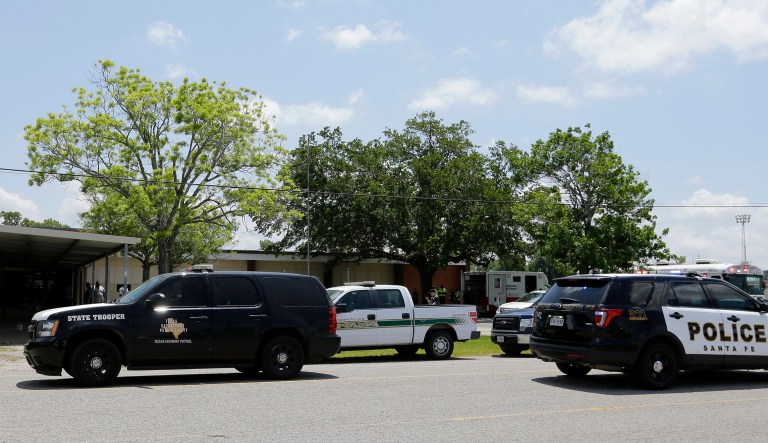 Law enforcement vehicles are parked outside the Alamo Gym where students and parents wait to reunite following a shooting at Santa Fe High School Friday, May 18, 2018, in Santa Fe, Texas. (AP Photo/David J. Phillip)