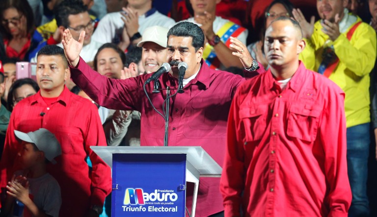 Venezuela's President Nicolas Maduro addresses supporters after the National Electoral Council said he was re-elected for a second six-year term at the presidential palace in Caracas, Venezuela, Sunday, May 20, 2018. 
