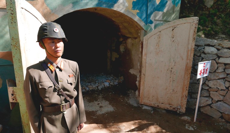 In this Thursday photo, a guard stands at the entrance of the north tunnel at North Korea's nuclear test site, which was blown up soon after this photo was made, in a display of dismantling the test site, at Punggye-ri, North Hamgyong Province, North Korea.