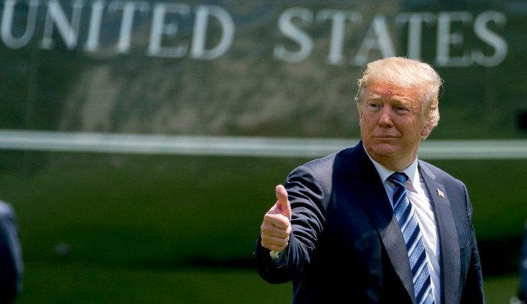 President Trump give a thumbs up to members of the media as he arrives on the South Lawn of the White House. 