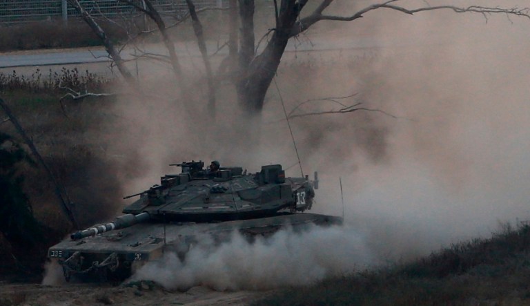 An Israeli tank drives along the border with the Gaza strip, on Israel-Gaza Border. 