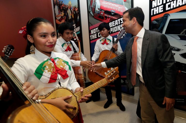 In this Tuesday, May 29, 2018 photo, Rep. Carlos Curbelo, R-Fla., shakes hands with band members while attending the 34th Annual Farmworker Student Recognition Ceremony in Homestead, Fla. In a district stretching from upscale Miami suburbs to the Everglades and down the Florida Keys to eccentric Key West, 70 percent of Curbeloâs constituents are Hispanic and nearly half are foreign born.