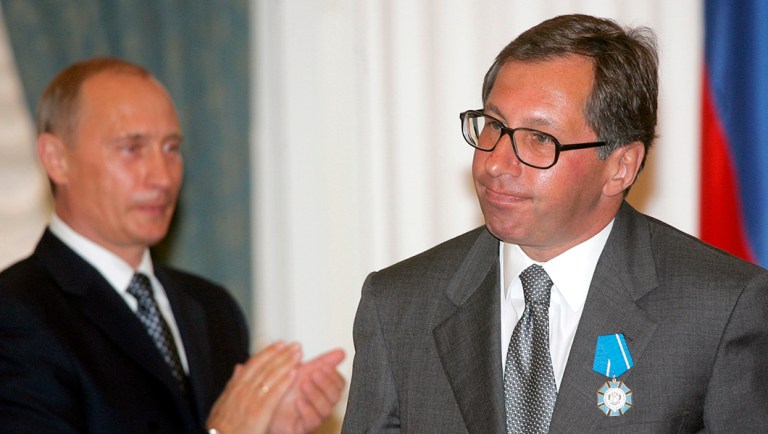 Russian President Vladimir Putin, left, applauds for Alfa Bank head Petr Aven after awarding him with the Order of Merit to the Fatherland during a ceremony at the Kremlin in Moscow.