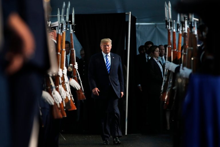 President Donald Trump walks through an honor guard as he arrives to attend a Change of Command ceremony at the U.S. Coast Guard Headquarters, Friday, June 1, 2018, in Washington. Adm. Paul Zukunft will be relieved by Adm. Karl Schultz as the Commandant of the U.S. Coast Guard.