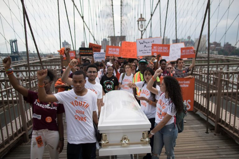 Demonstrators carry a coffin over the Brooklyn Bridge during a march and rally against gun violence on Saturday, June 2, 2018. Youth Over Guns, a gun violence prevention organization in New York City, lead a march across the Brooklyn Bridge to call for youth empowerment and investment in urban communities to end gun violence. 