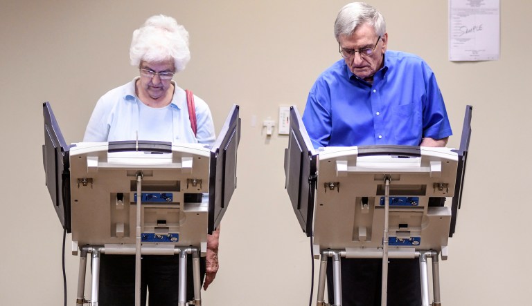 Nila, left, and Max Williams vote in the U.S. congressional election primaries at the Oxford Conference Center in Oxford, Miss. on Tuesday, June 5, 2018.  Mississippi voters on Tuesday are casting ballots in party primaries for one U.S. Senate seat and two U.S. House seats. 