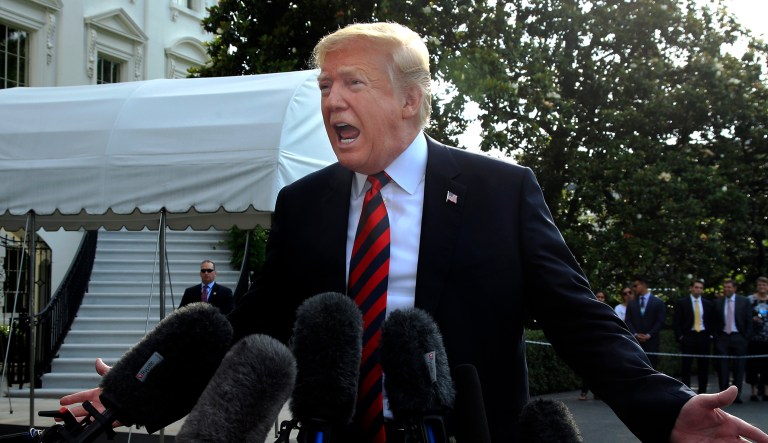 President Trump speaks to reporters before leaving the White House in Washington.