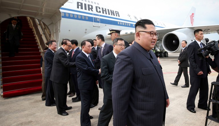 In this photo released by the Ministry of Communications and Information of Singapore, North Korean leader Kim Jong Un, right, arrives at the Changi International Airport, Sunday, June 10, 2018, in Singapore ahead of a summit with U.S. President Donald Trump. 