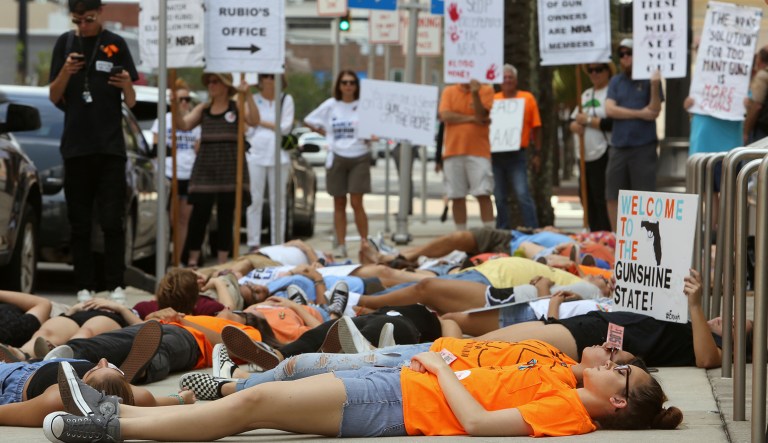 Around 50 protesters from "We The Students" and "March For Our Lives, Tampa" demonstrate in front of Marco Rubio's office in Tampa Tuesday, June 12, 2018. They rallied against gun violence for an hour before staging a "die in" on the sidewalk in silent protest for 12 minutes.