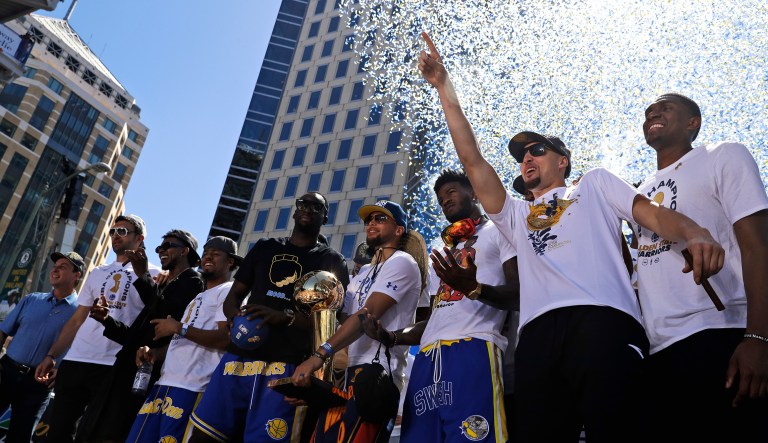 Members of the Golden State Warriors gather before the start of the team's NBA basketball championship parade on Tuesday in Oakland, Calif.
