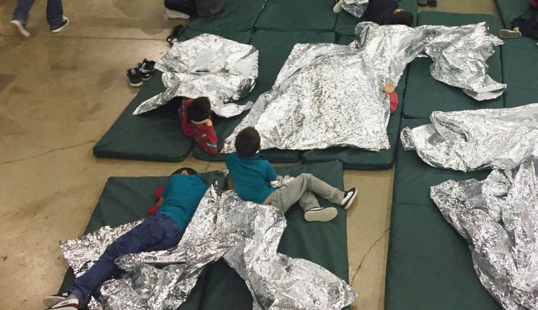 In this photo provided by U.S. Customs and Border Protection, people who've been taken into custody related to cases of illegal entry into the United States, rest in one of the cages at a facility in McAllen, Texas, Sunday, June 17, 2018. 
