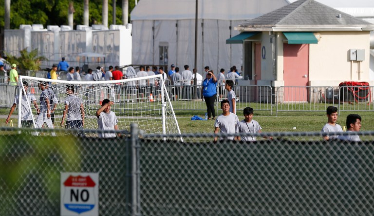 Immigrant children play outside a former Job Corps site that now houses them, Monday, June 18, 2018, in Homestead, Fla. It is not known if the children crossed the border as unaccompanied minors or were separated from family members. Wrenching scenes of migrant children being separated from their parents at the southern border are roiling campaigns ahead of midterm elections, emboldening Democrats on the often-fraught issue of immigration.